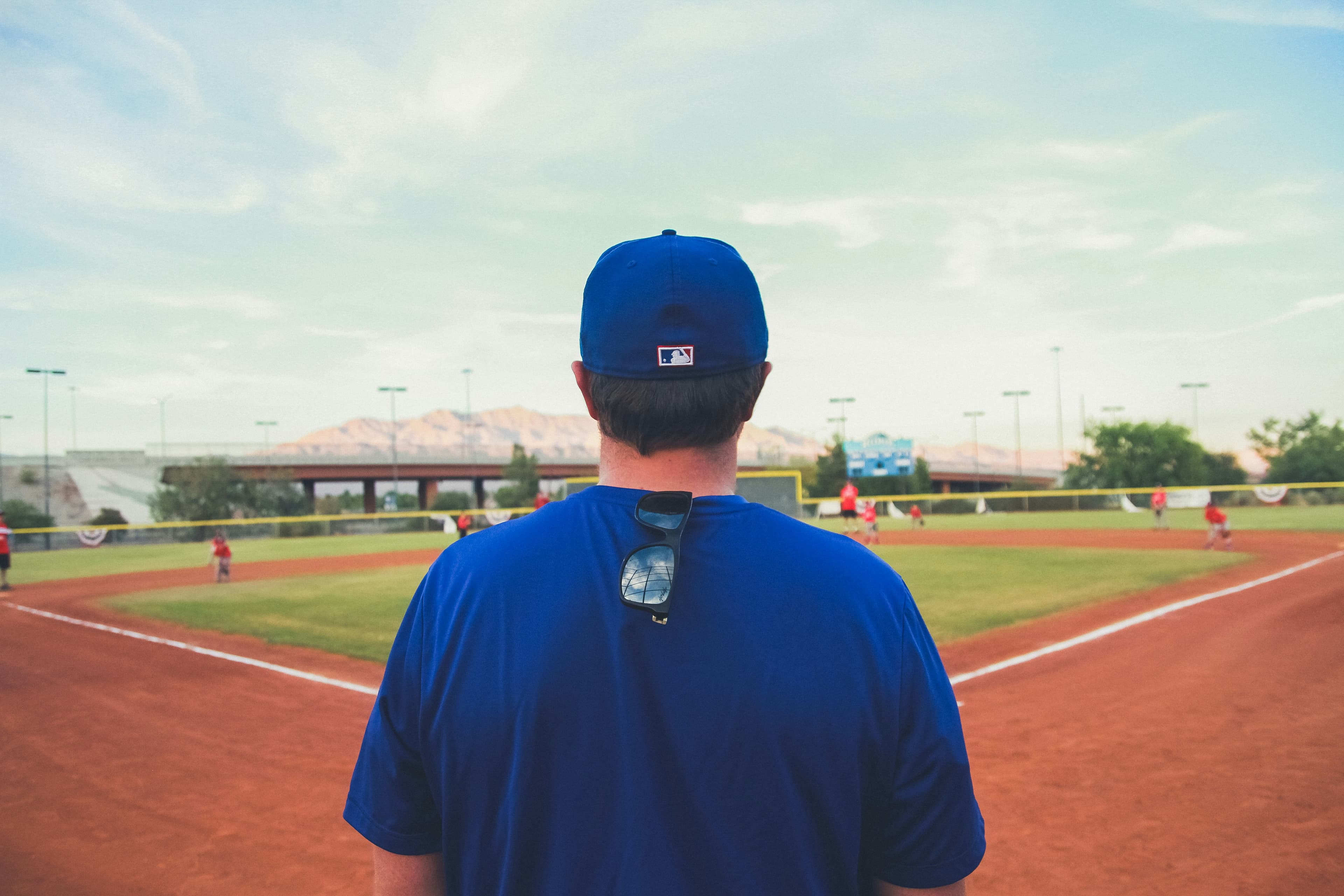 Baseball coach reviewing performance with athletes in a training facility