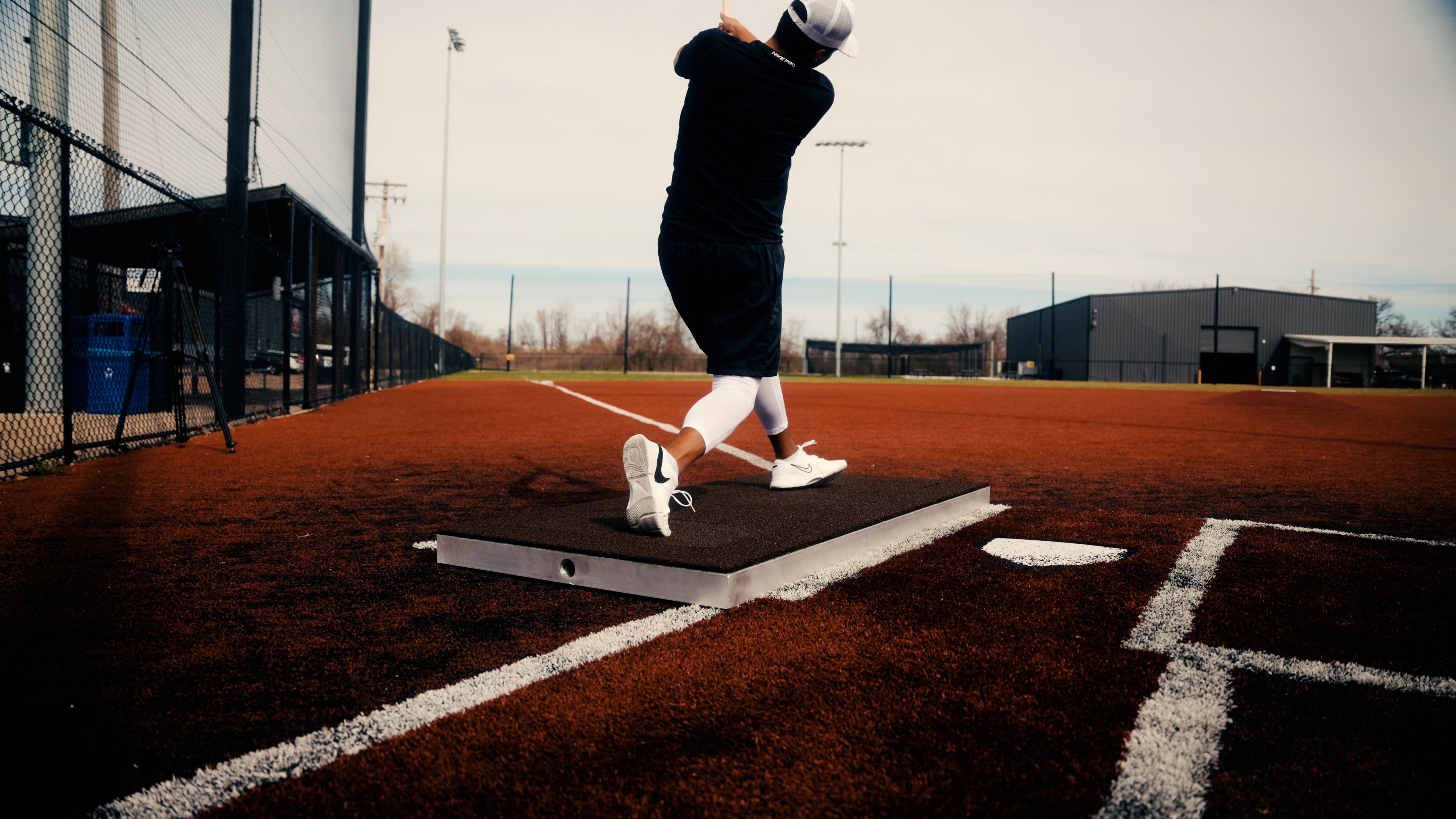 Hitter mid-swing on an Axioforce instrumented batter's box